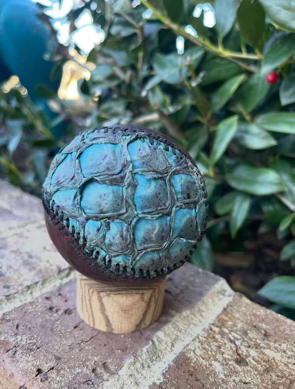 Turquoise and brown scaled exotic baseball